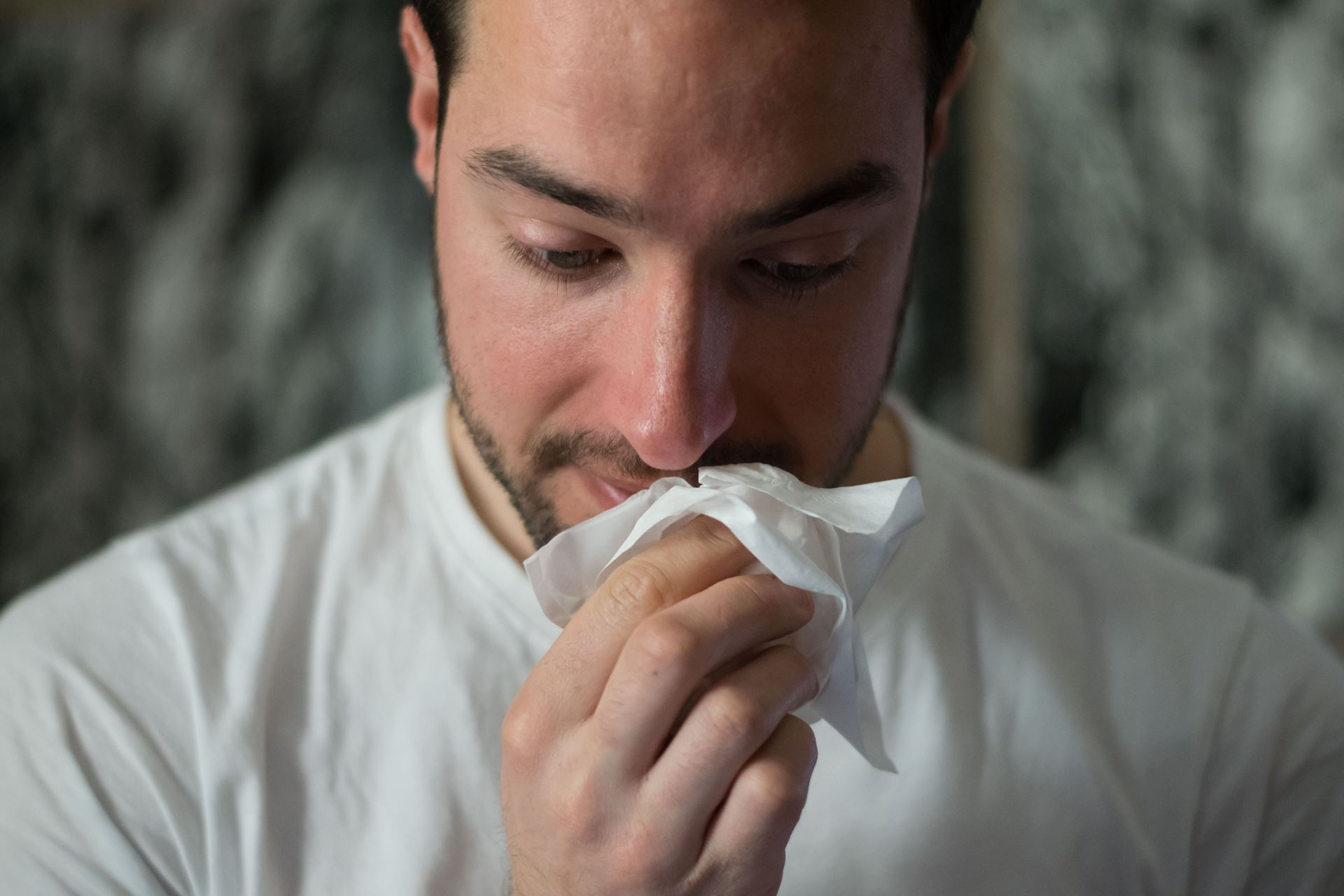 a man holding a tissue